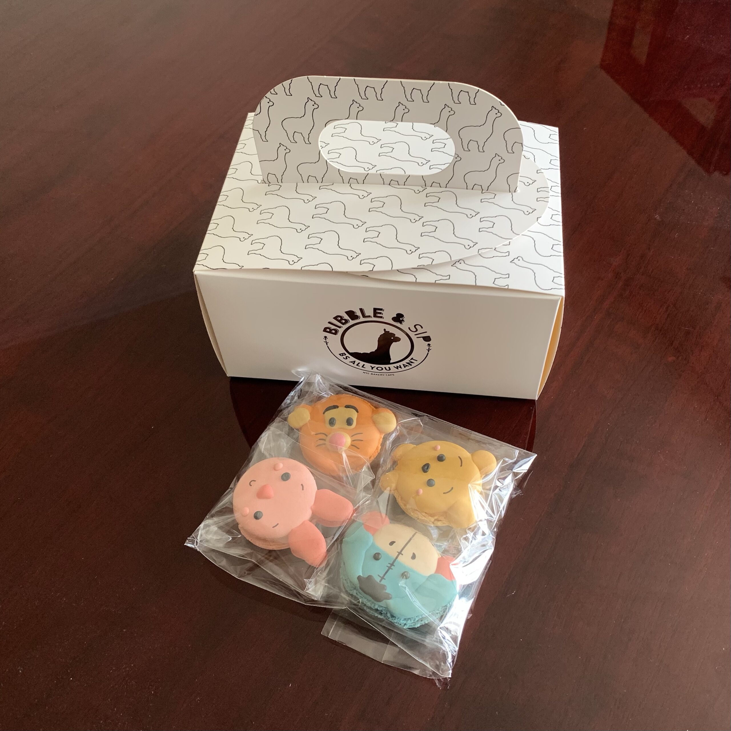 Winnie-the-Pooh Macarons in front of a Bibble and Sip box.